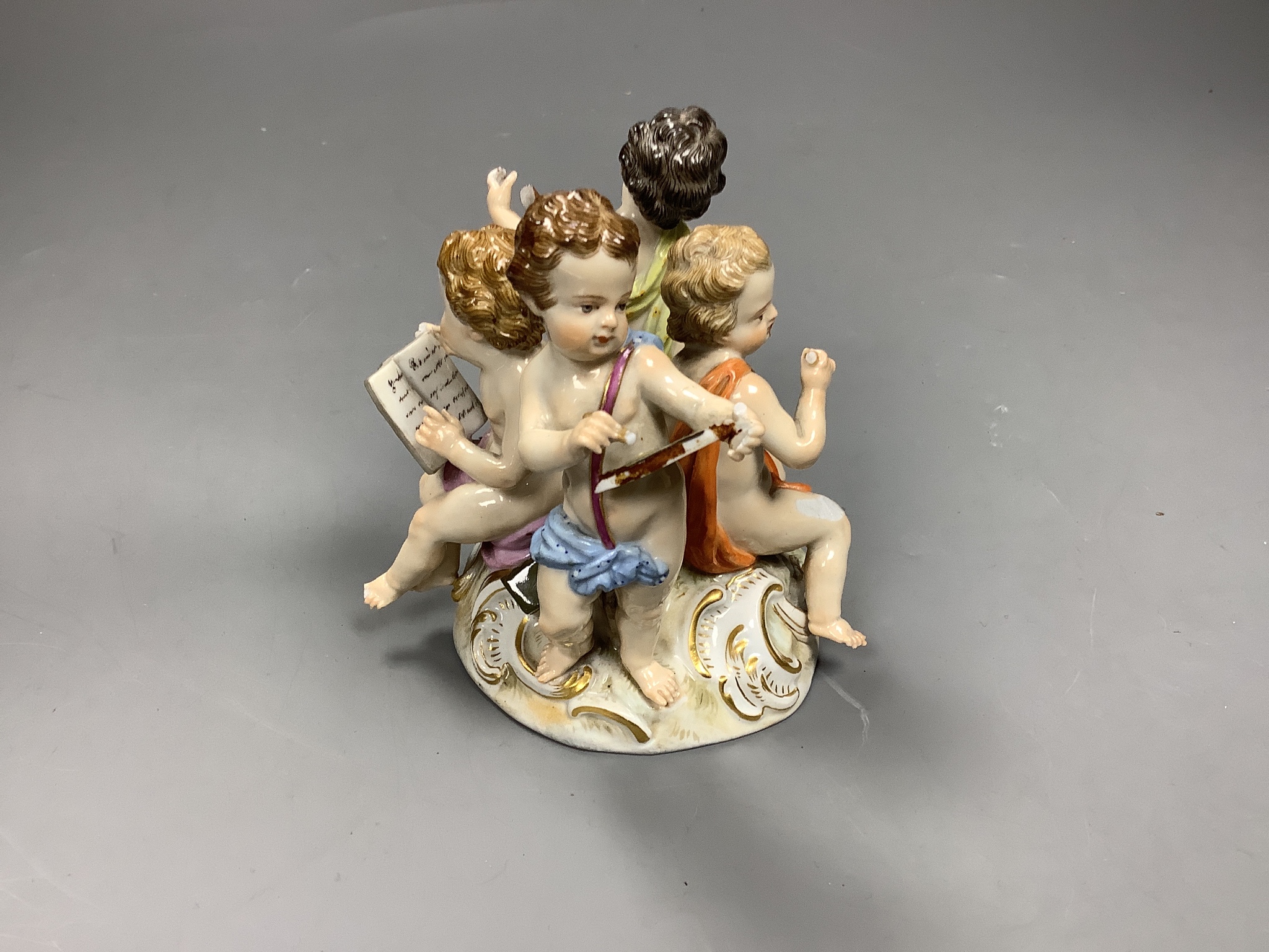 A Meissen group of four putti musicians, late 19th century, 11 cm high, losses